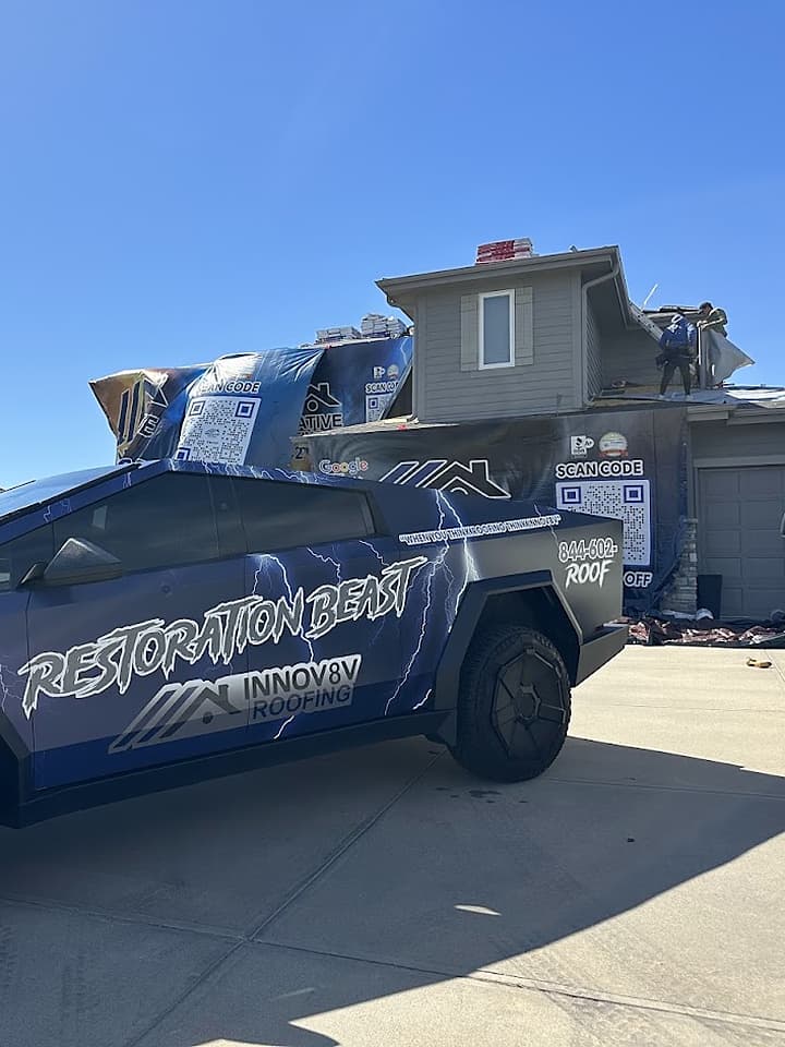 Innov8v Roofing Restoration Beast Cybertruck parked at a residential job site with branded banners on the house
