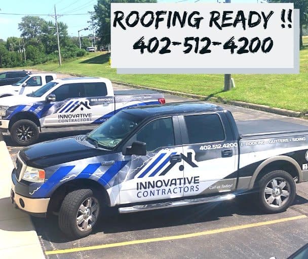 Two Innovative Contractors pickup trucks with full vinyl wraps advertising roofing, gutters, and siding