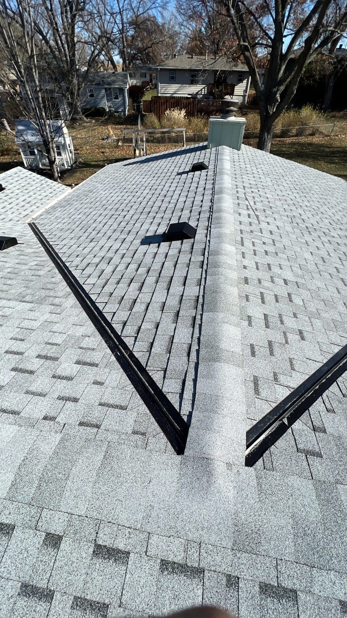 Long view along a roof ridge covered in protective white underlayment