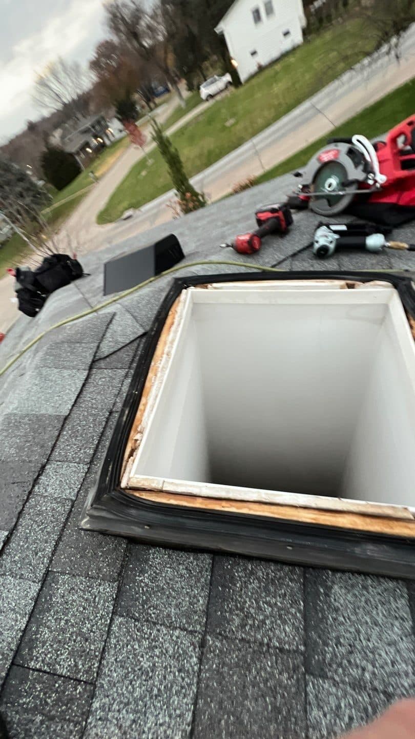 Roof during construction showing a rectangular skylight opening in the decking