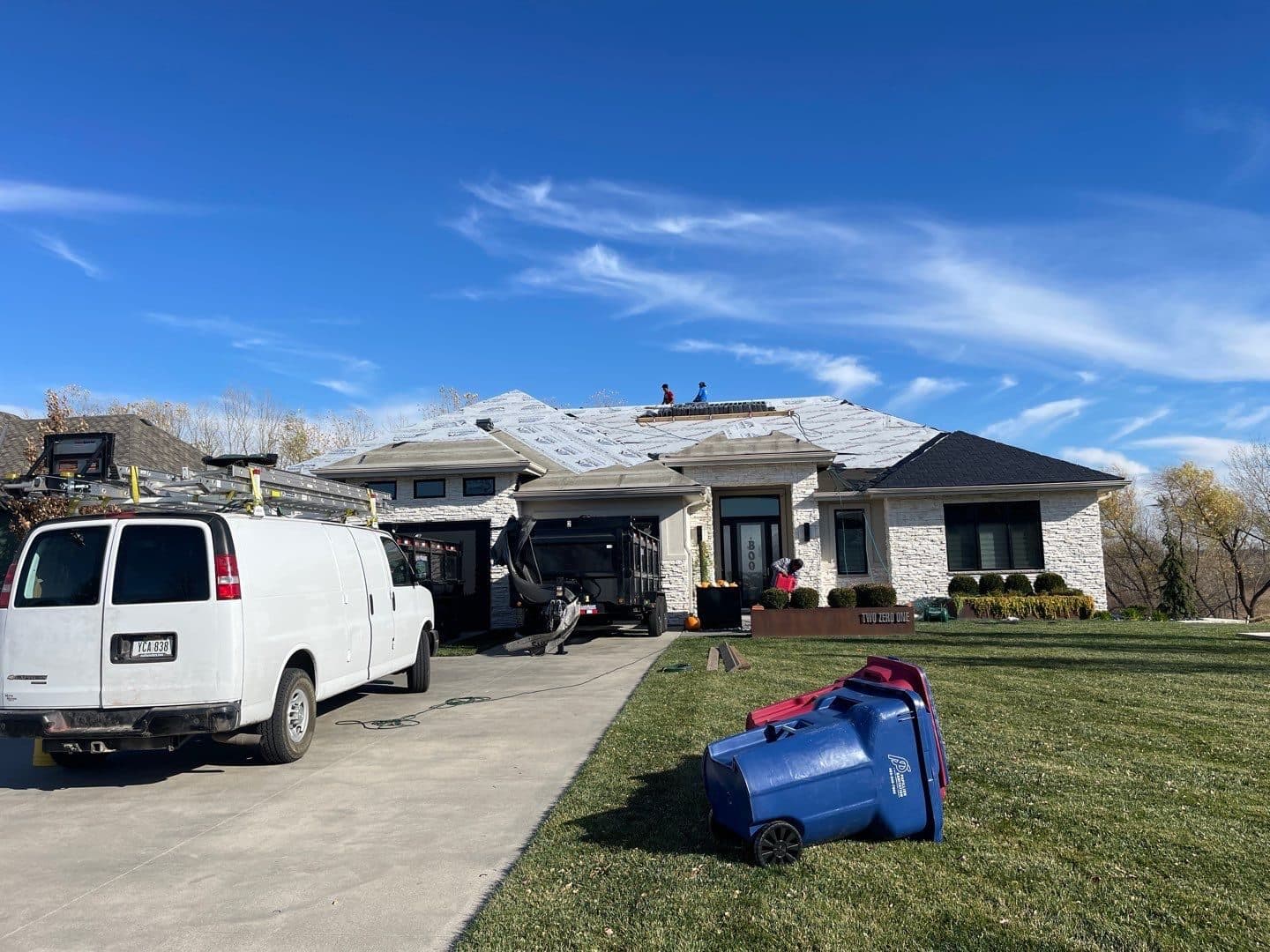 White Innovative Roofing service van parked at a stone home during a job
