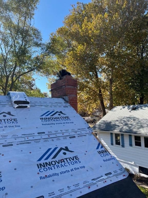 Roof partially covered in blue Innovative Roofing branded underlayment