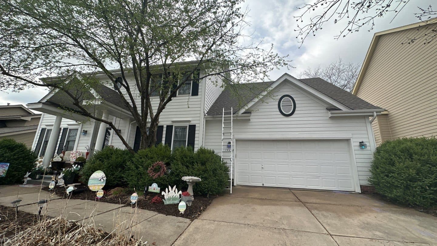 Large white multi-gable home with a dark gray finished roof