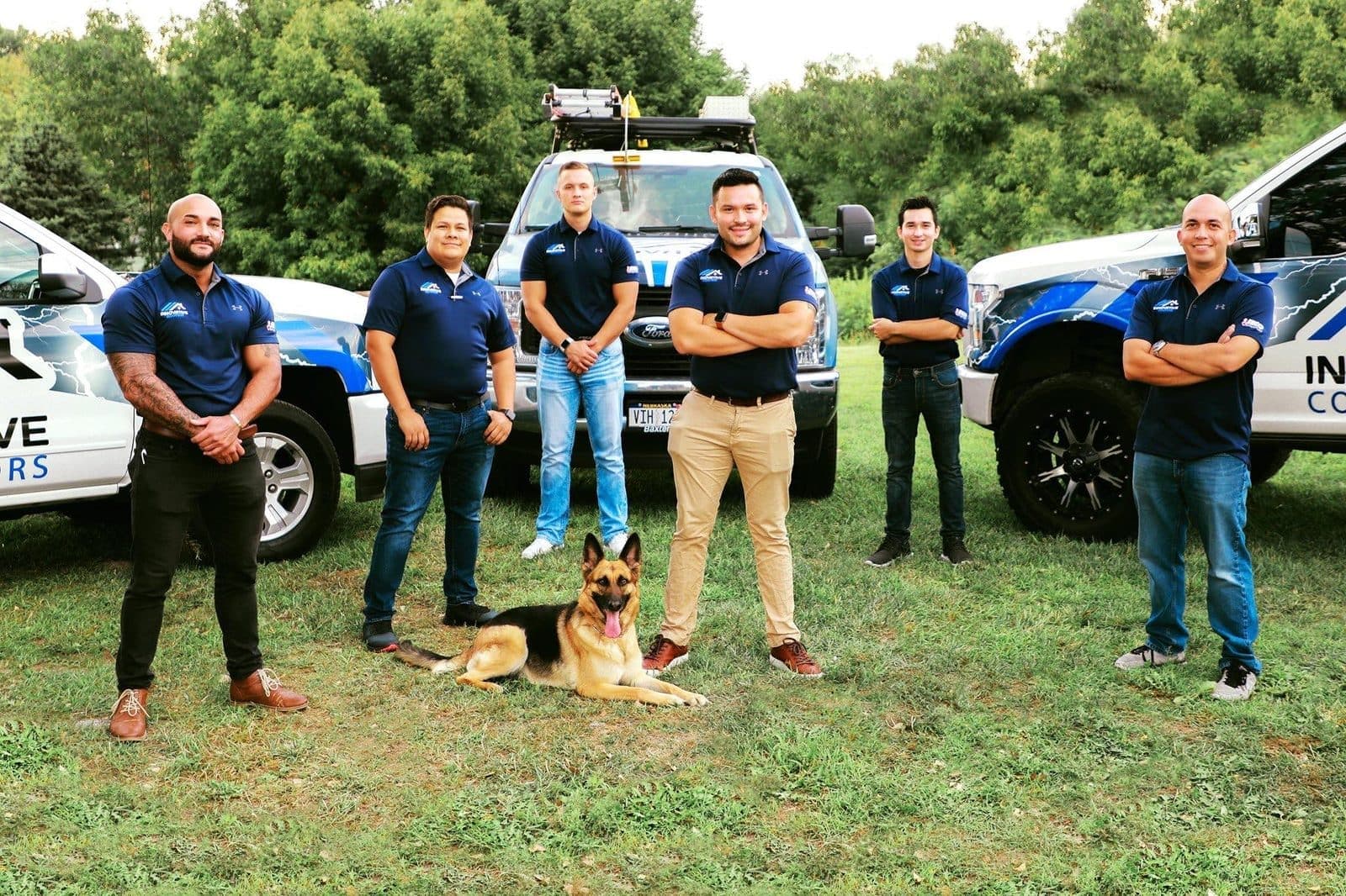 Innovative Roofing team standing with company trucks